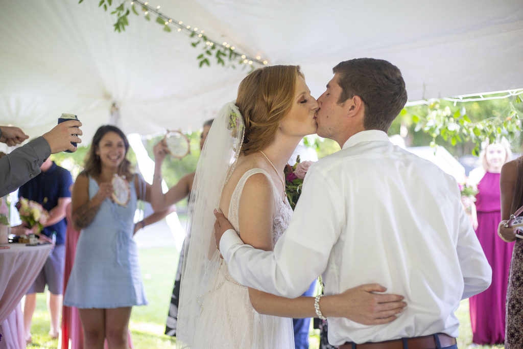 Carmen and Chris kiss to the sounds of tambourines ringing