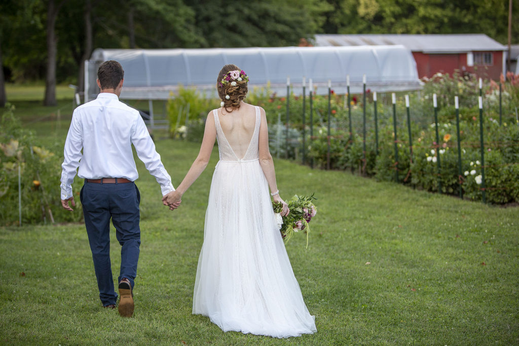 Carmen and Chris walking hand-in-hand towards the gardens