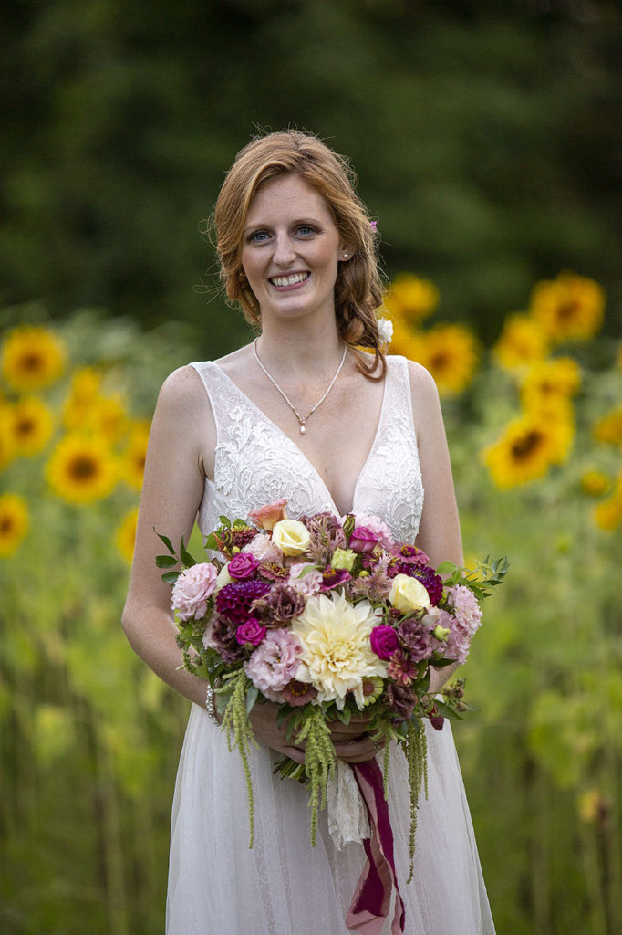 Stunning Carmen standing in front of the sunflower fields