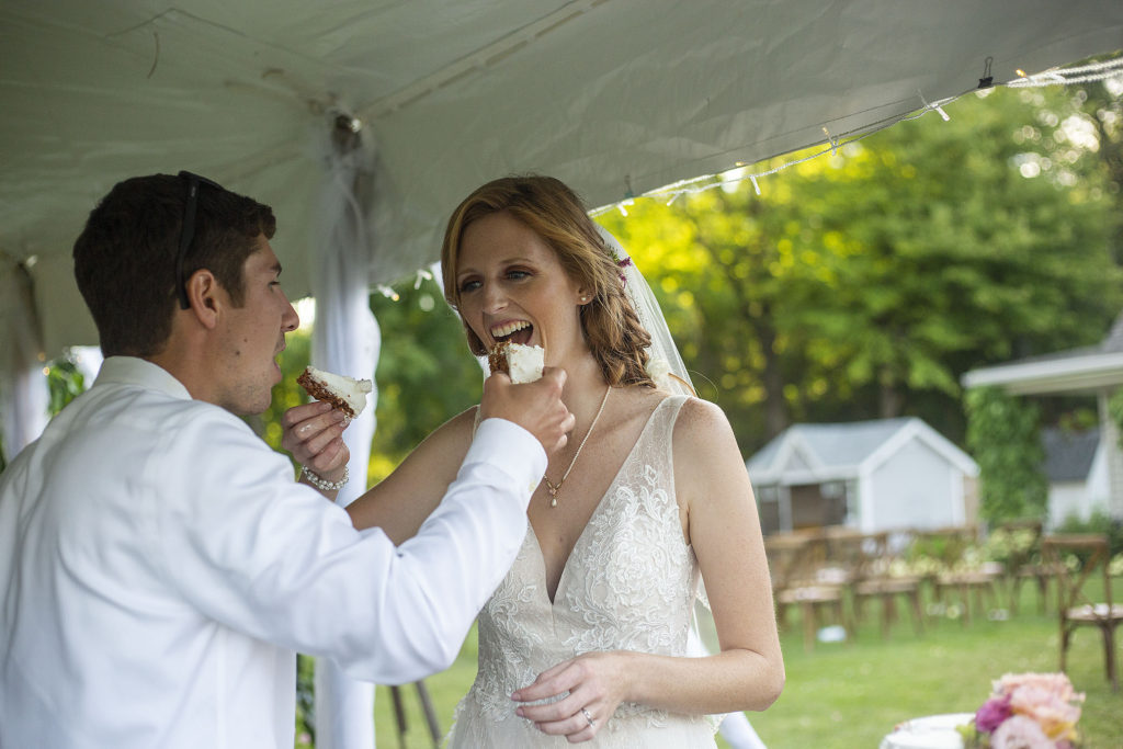 Feeding each other wedding cake