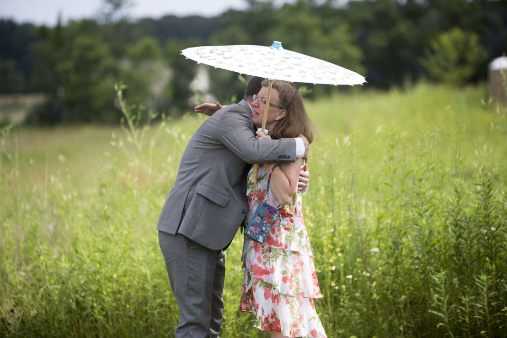 Ypsilanti groom and mother hugging during Michigan summer wedding