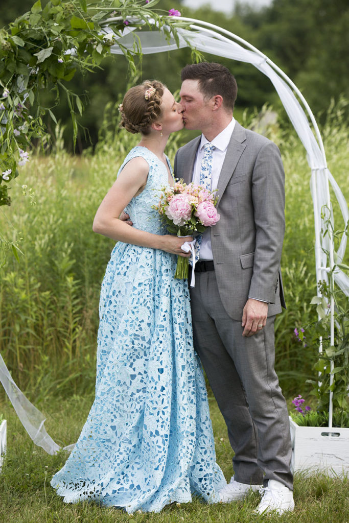 Ypsilanti wedding couple kissing in the fields of Conservancy Farms