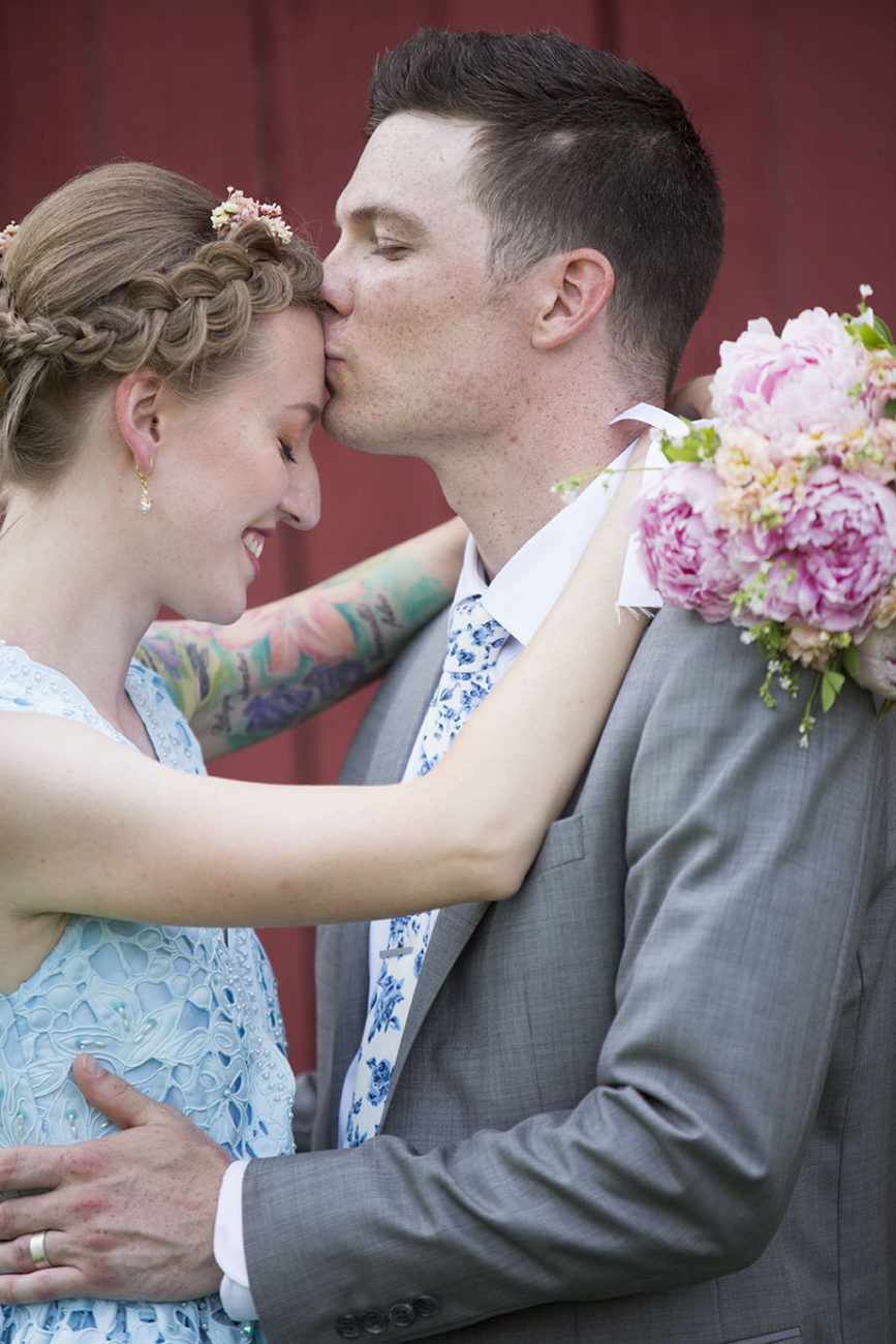 Groom kisses brides forehead Ypsilanti wedding
