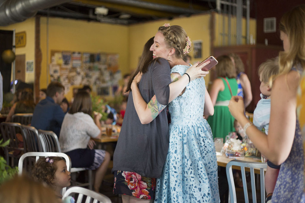 Bride hugs guest at her Ypsilanti wedding reception