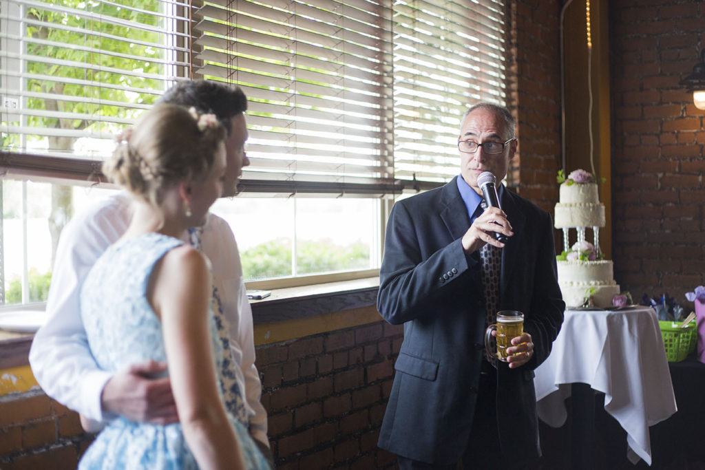 Father looks at Ypsilanti wedding couple