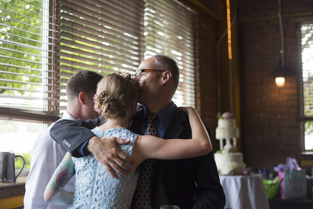 Father kisses daughter on her Ypsilanti wedding day