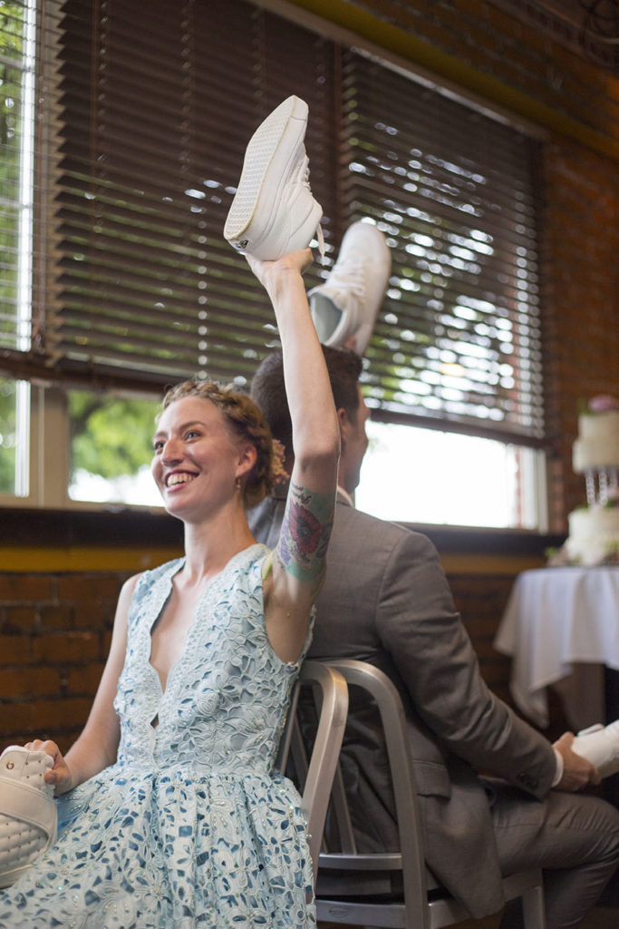 Ypsilanti wedding couple holding up shoes