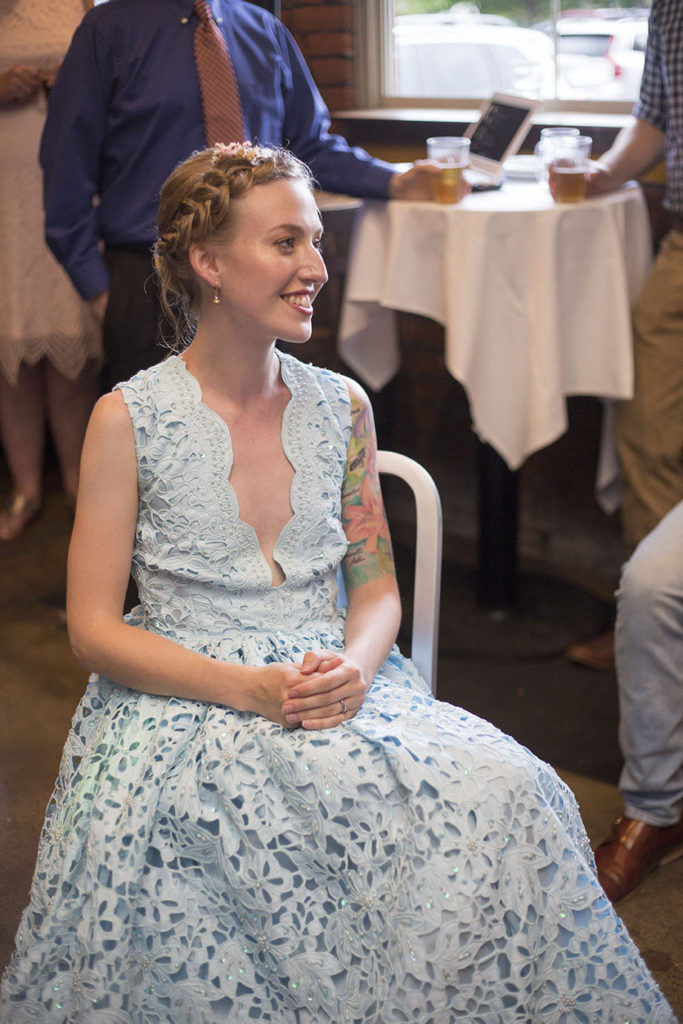 Bride longingly looks at groom while he sings at Ypsilanti wedding reception