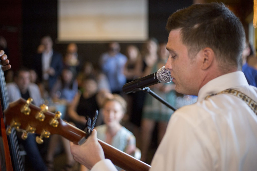 Groom singing at Ypsilanti wedding reception at Corner Brewery