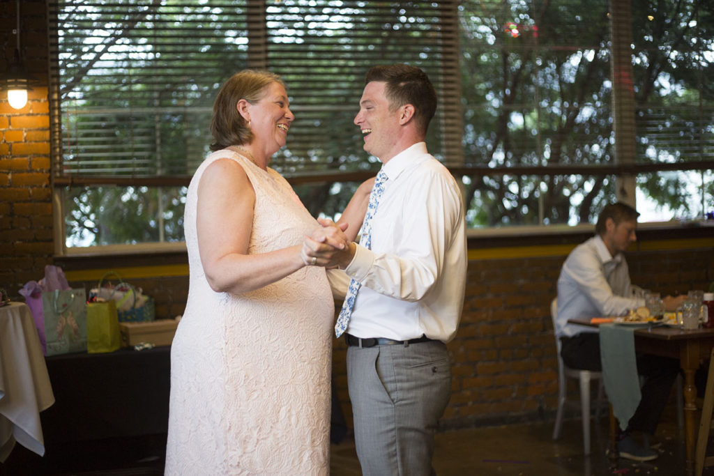 Mother and son share a joke during their dance together