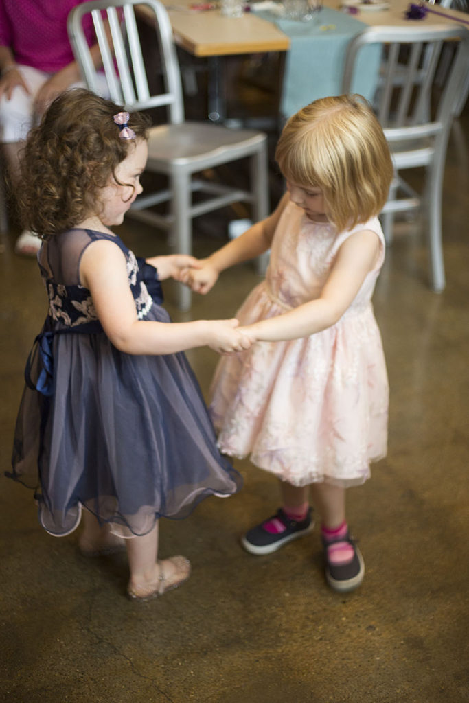 Little girls dancing in their twirly dresses at Ypsilanti wedding reception