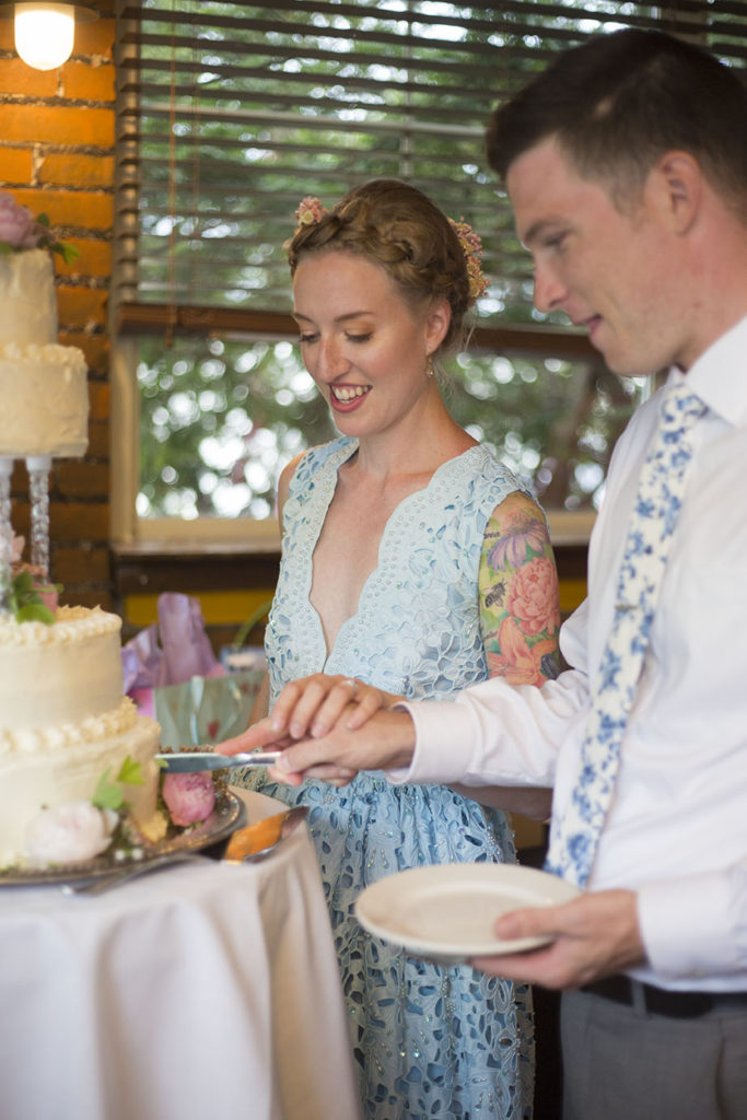 Rachel and Wade cutting the wedding cake at their Ypsilanti wedding reception