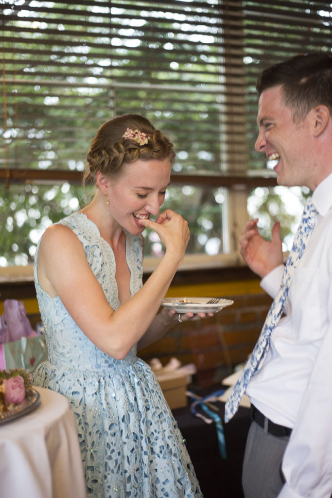 Laughing hard after the cake cutting during Ypsilanti wedding reception at Corner Brewery