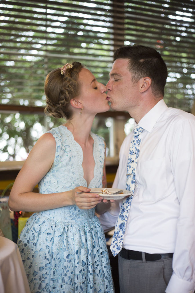 A sweet kiss after the cake is cut