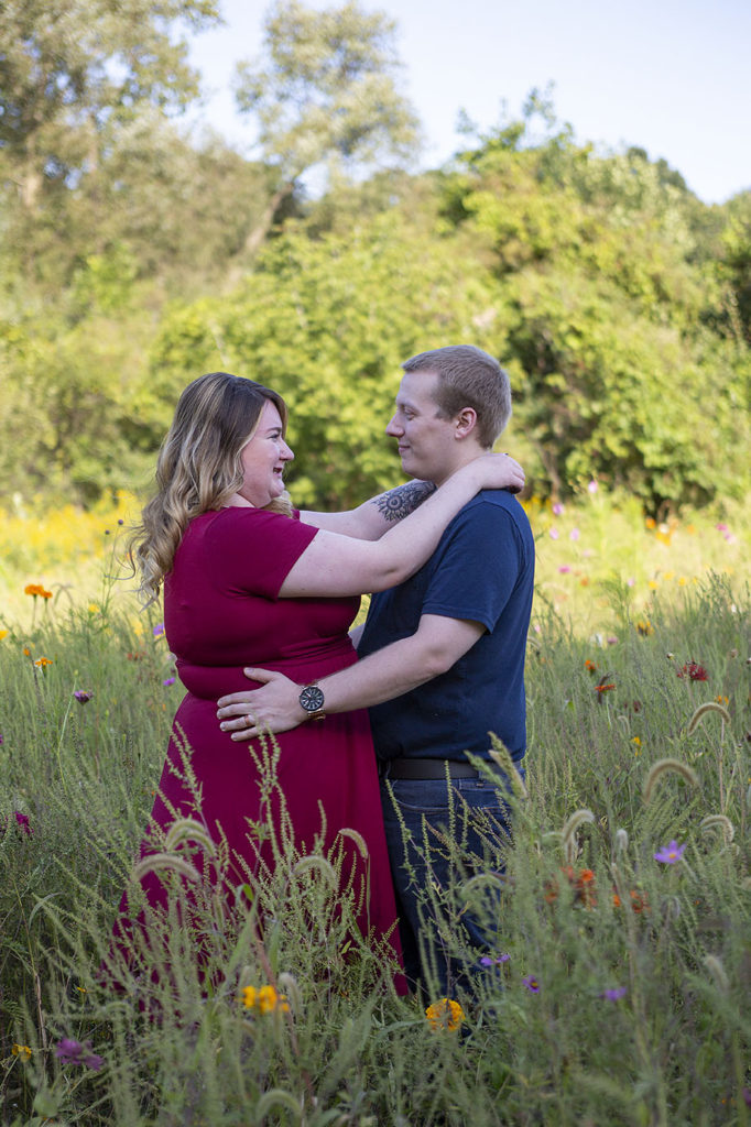 Pinckney couple embrace in a field of wildflowers