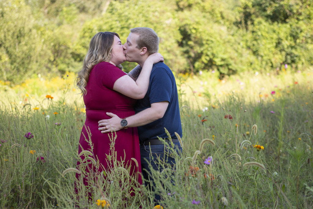 Michigan couple kissing in wildflowers