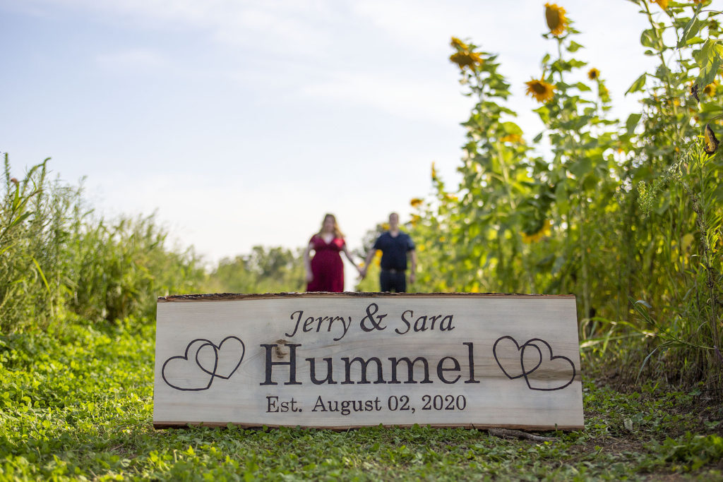 Couple with wood burned sign