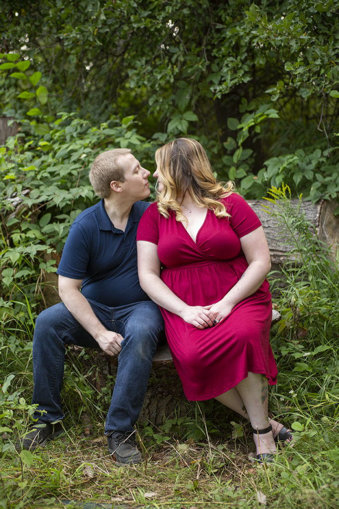 Couple kissing on a stump