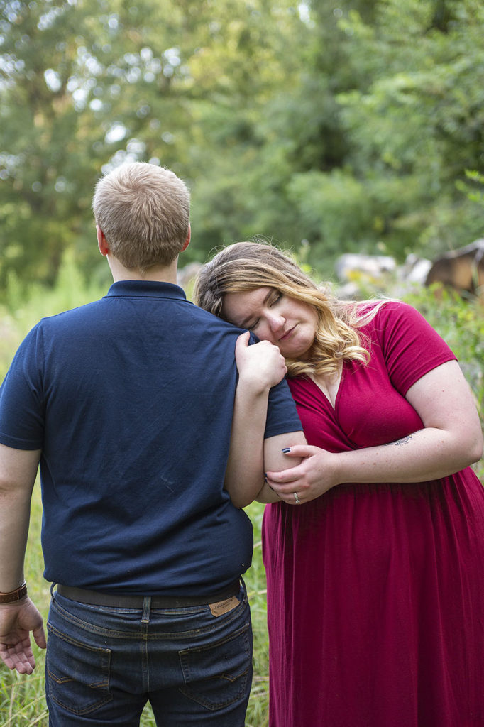 Woman cuddles up to her fiancé