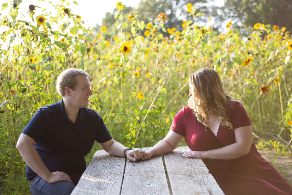 Pinckney couple holding hands at the picnic table