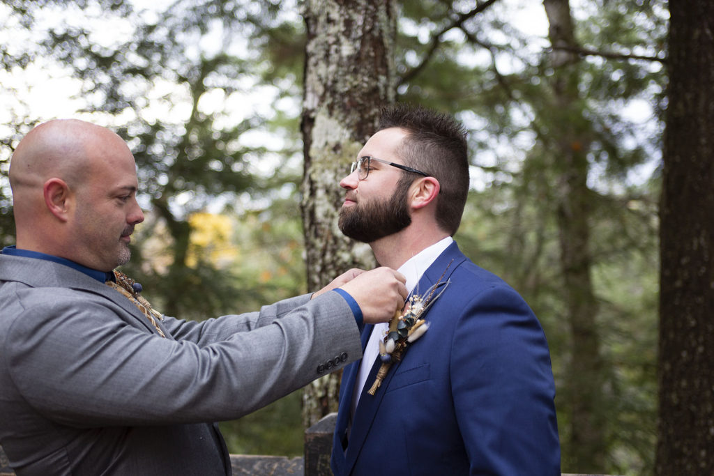 Best man straightens groom's bowtie