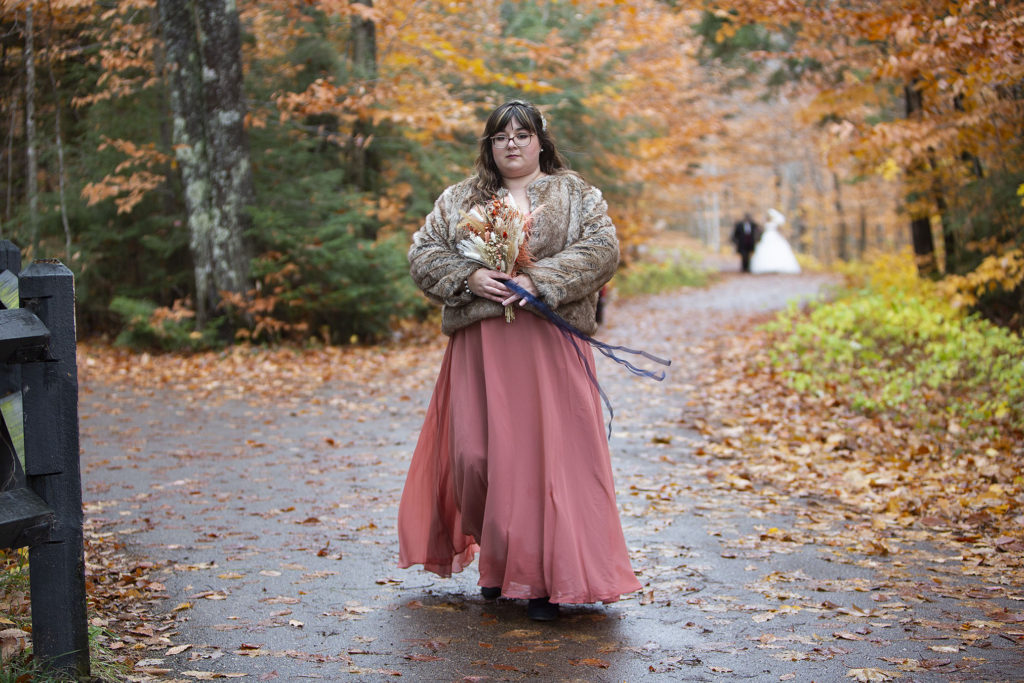 Bridesmaid walking down the aisle Tahquamenon Falls elopement