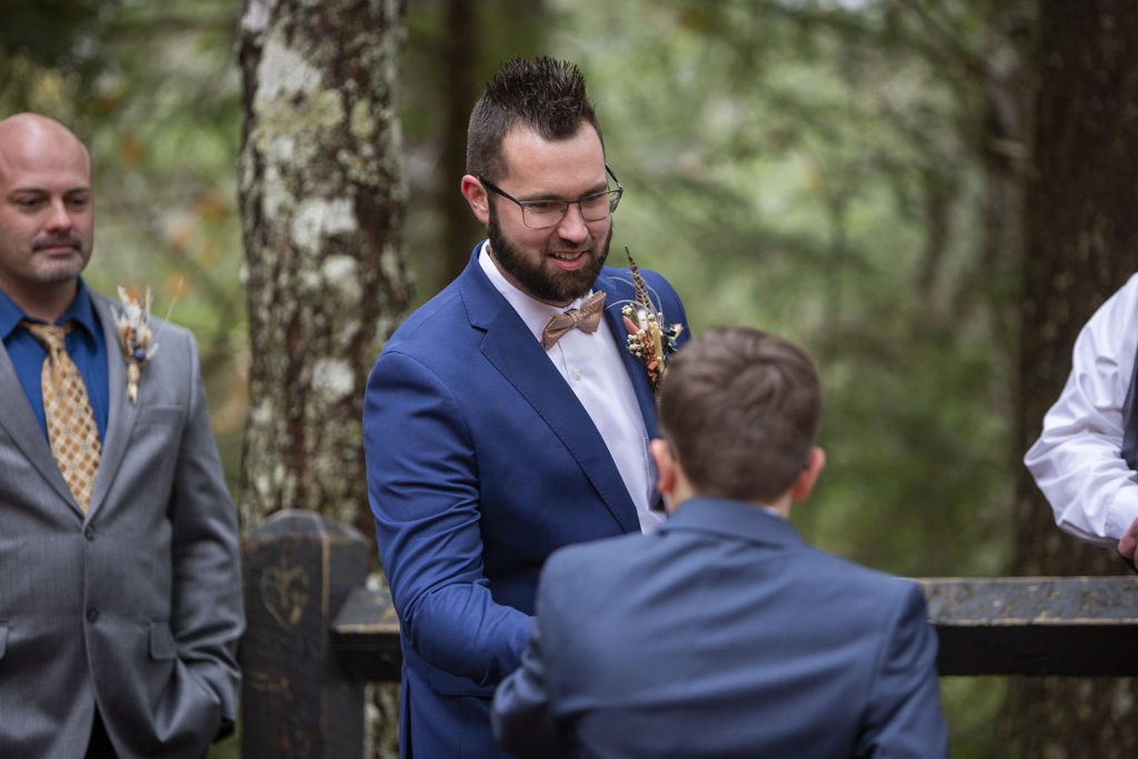 Groom shakes son's hand Tahquamenon Falls elopement