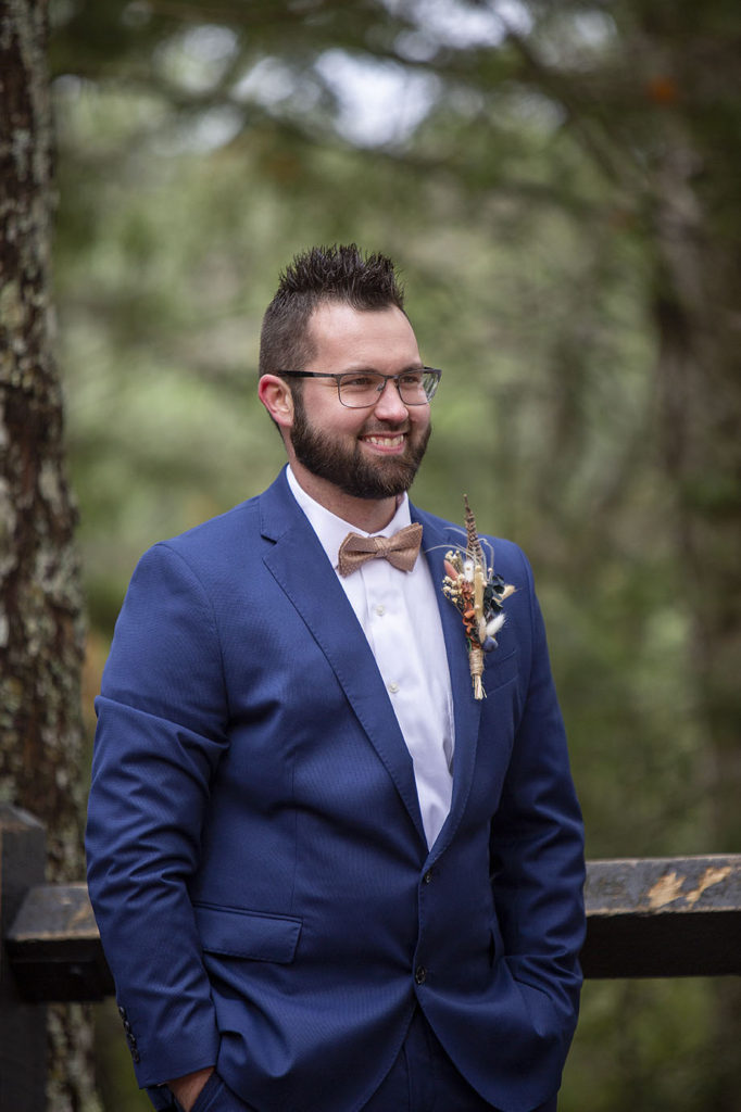 Tahquamenon Falls elopement groom beaming as he sees his bride for the first time