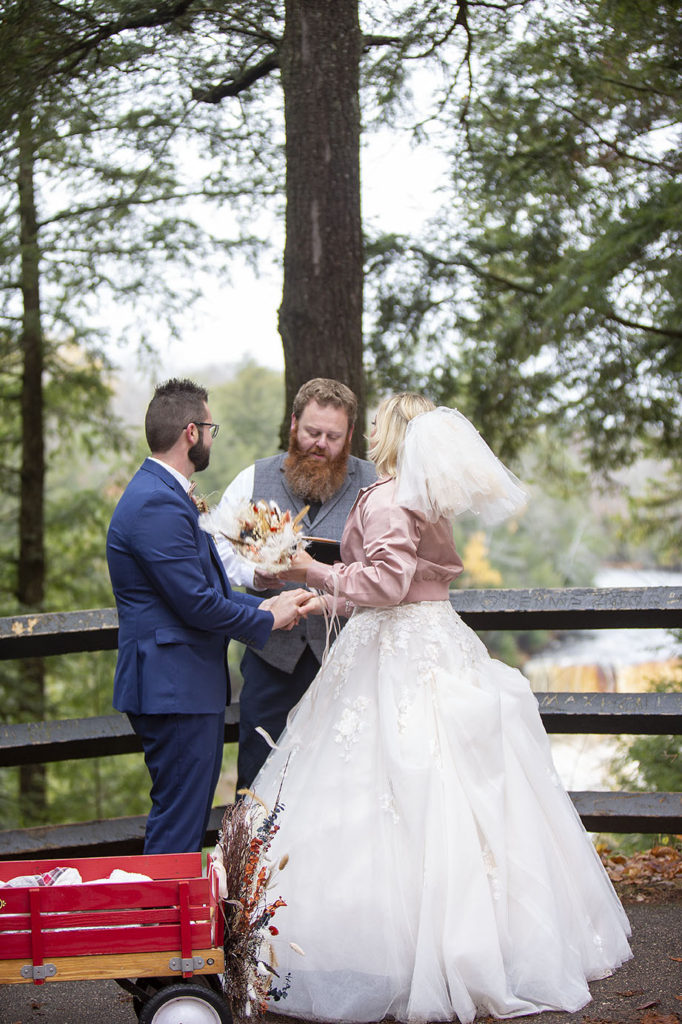 Paradise MI wedding couple stands with officiant