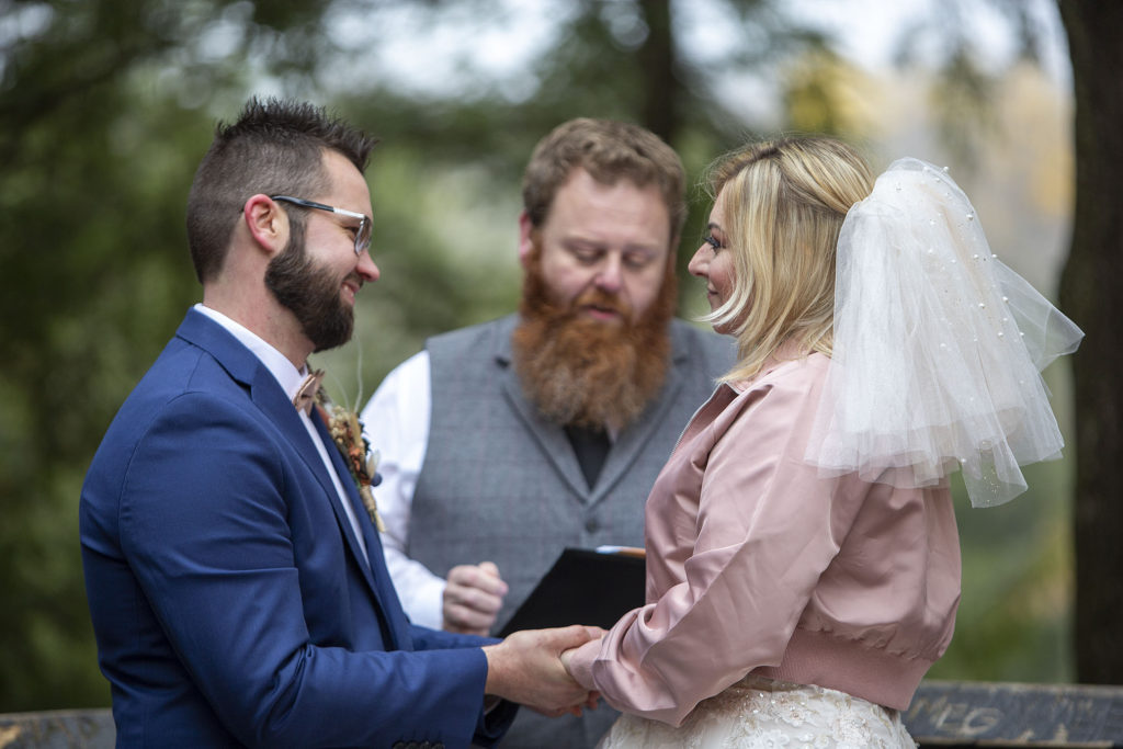 Wedding couple smiling at each other during Tahquamenon Falls elopement