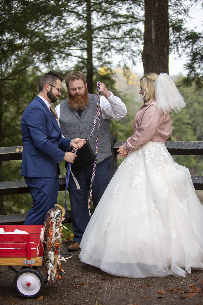 Tahquamenon Falls elopement officiant performing hand fasting ceremony