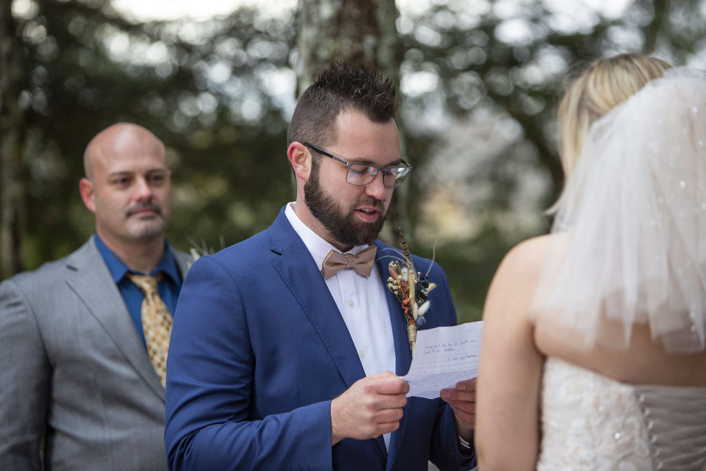 Northern Michigan groom reading vows at Paradise MI wedding