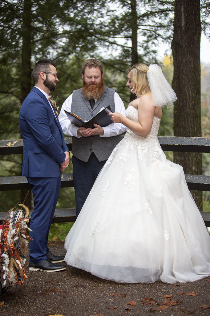 Bride reading wedding vows during Northern Michigan elopement