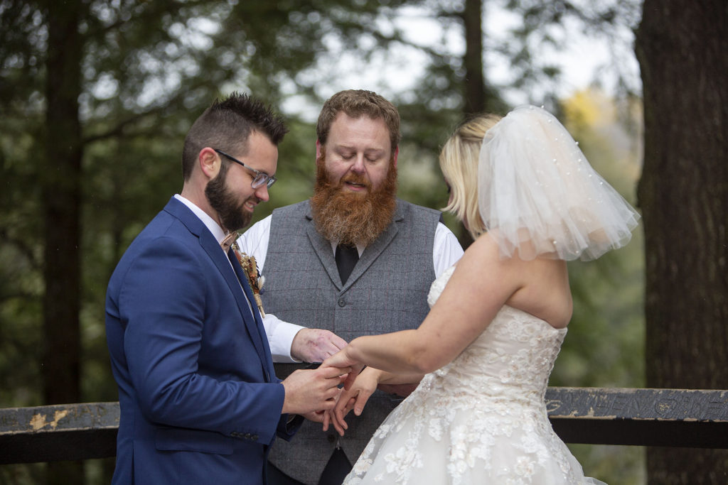 Officiant blessing the rings at Tahquamenon Falls elopement