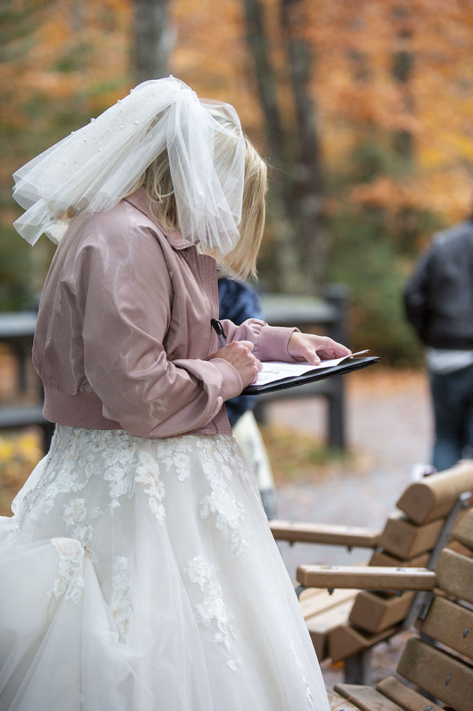 Bride signing marriage license Tahquamenon Falls elopement