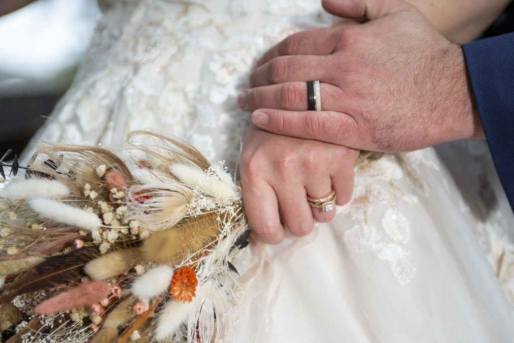 Wedding rings and fall bouquet Tahquamenon Falls elopement