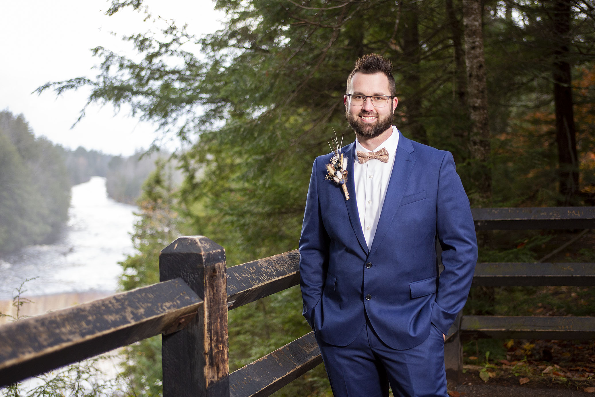 Groom in front of Tahquamenon Falls