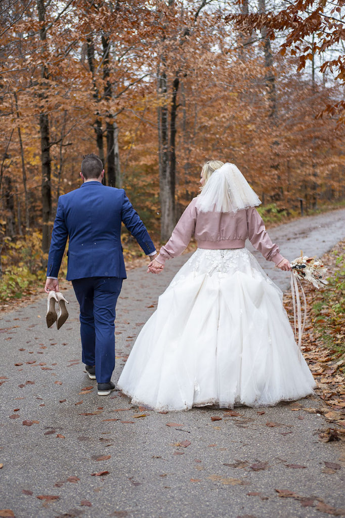 Groom carrying bride's heals Tahquamenon Falls elopement