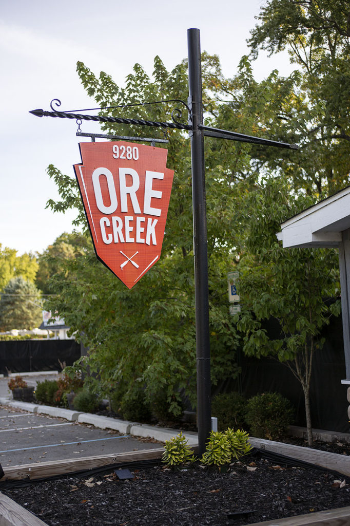 The orange Ore Creek sign