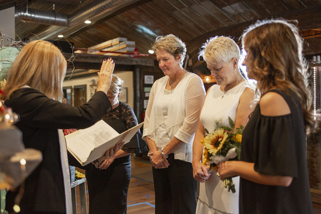 Officiant blessing the same sex couple