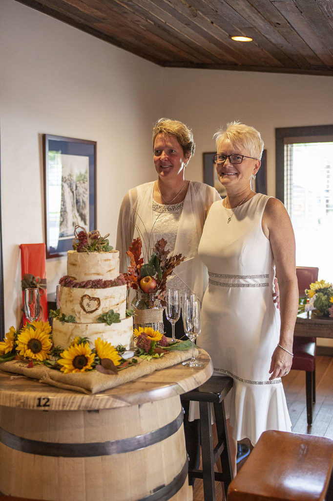 Pinckney same sex couple cutting the cake