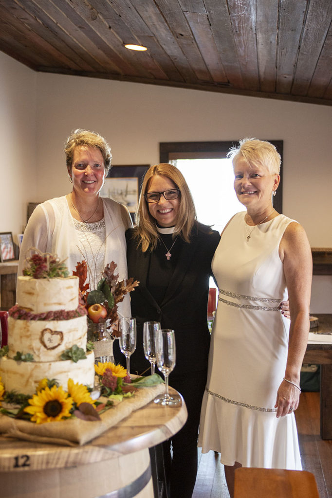 Michigan lesbian couple pose with officiant