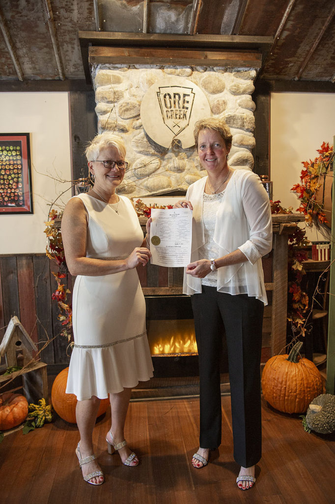 Ann Arbor LGBTQ couple poses with marriage certificate