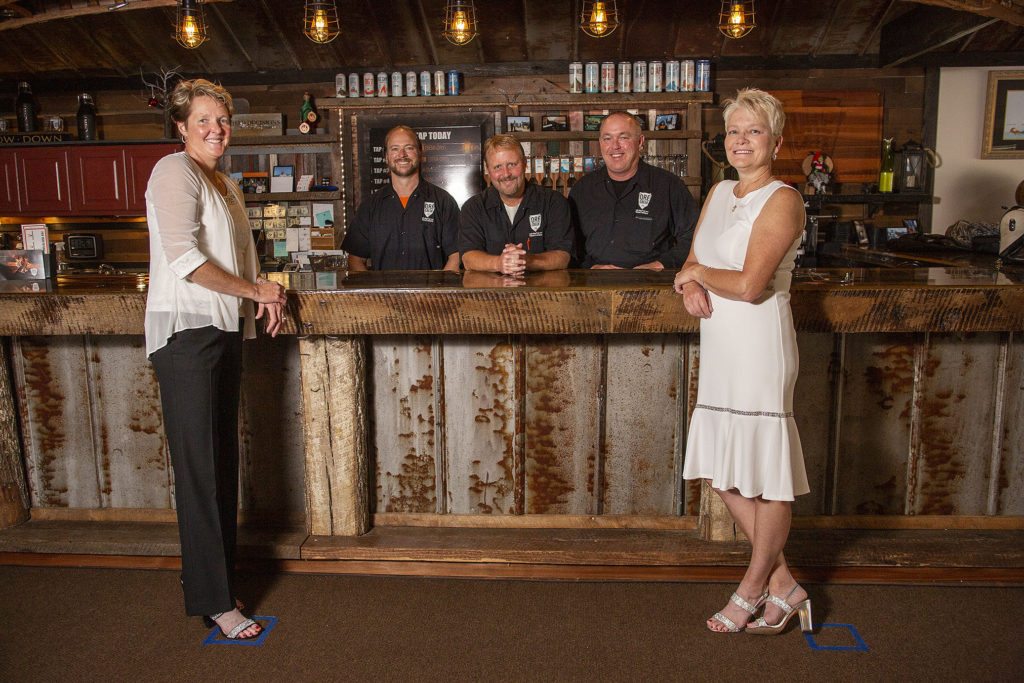 Lesbian brides pose with owners of Ore Creek Cidery