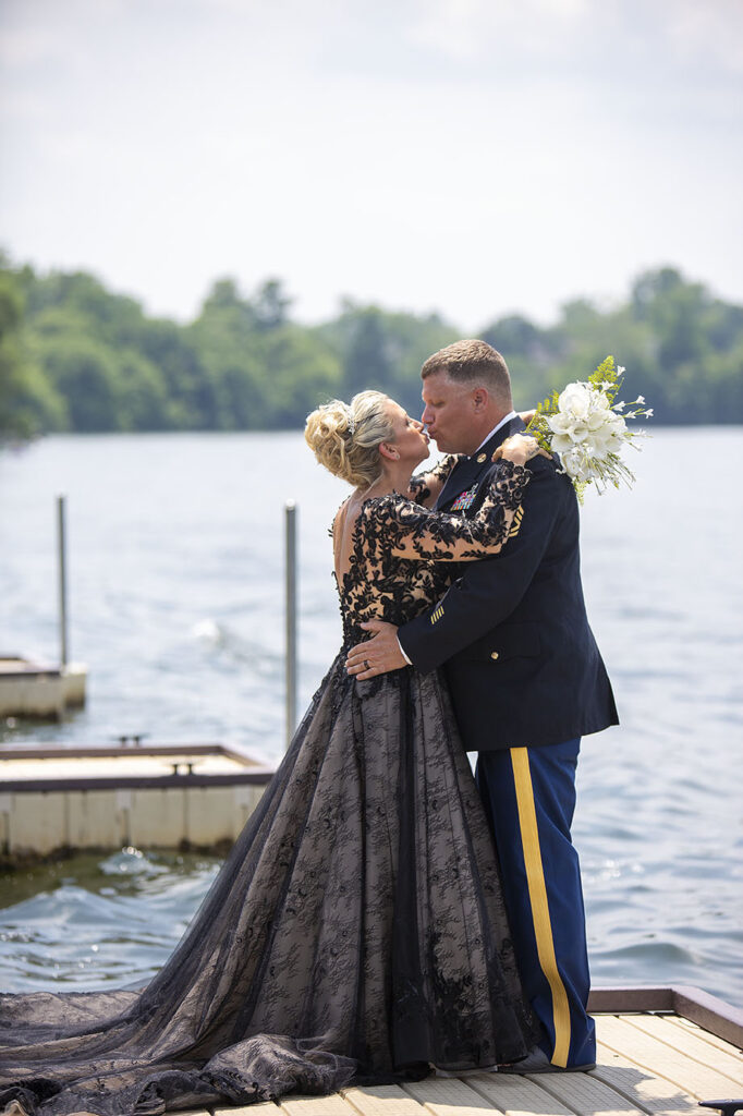 Couple kissing on dock at Belleville Lake wedding