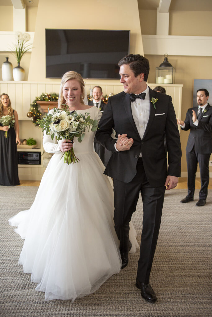 Couple happily walks up the aisle after being announced as married winter elopement