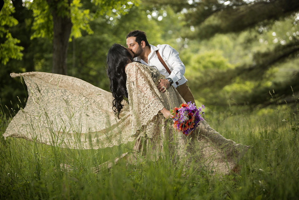 Michigan boho wedding couple dips and kisses