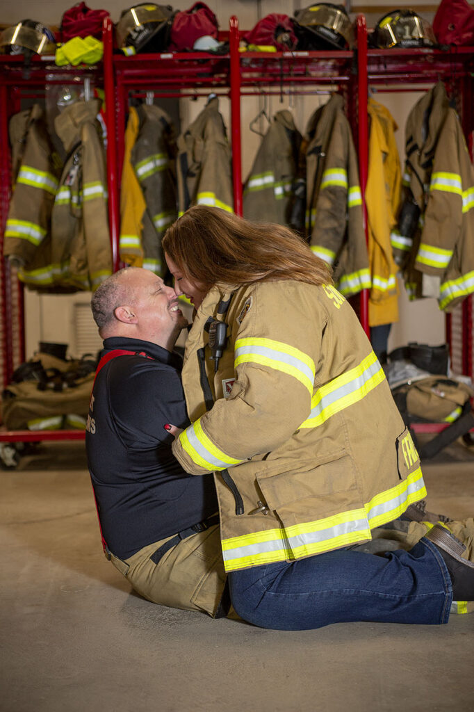 Couple kisses during fire department engagement session