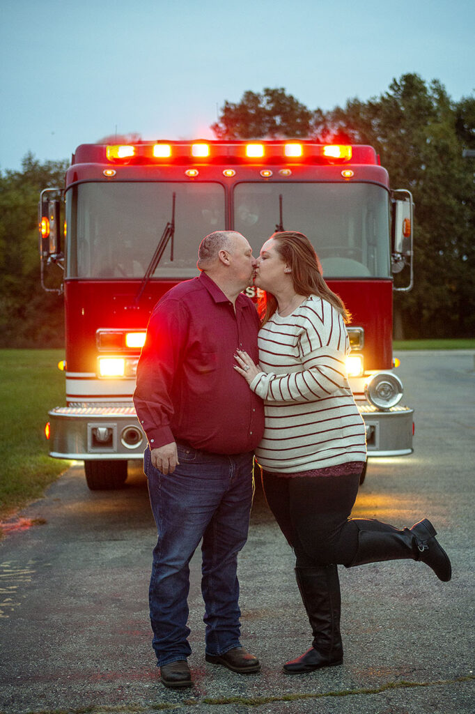 Jackson MI couple kisses in front of fire engine during fire department engagement session