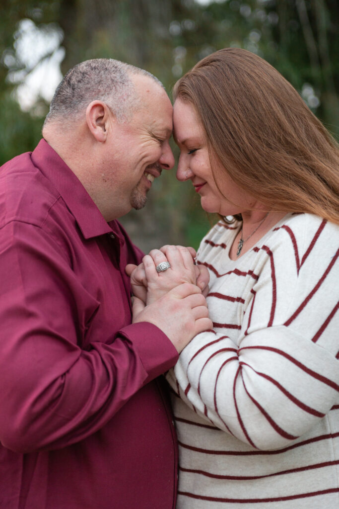 Fire department engagement couple touches foreheads together